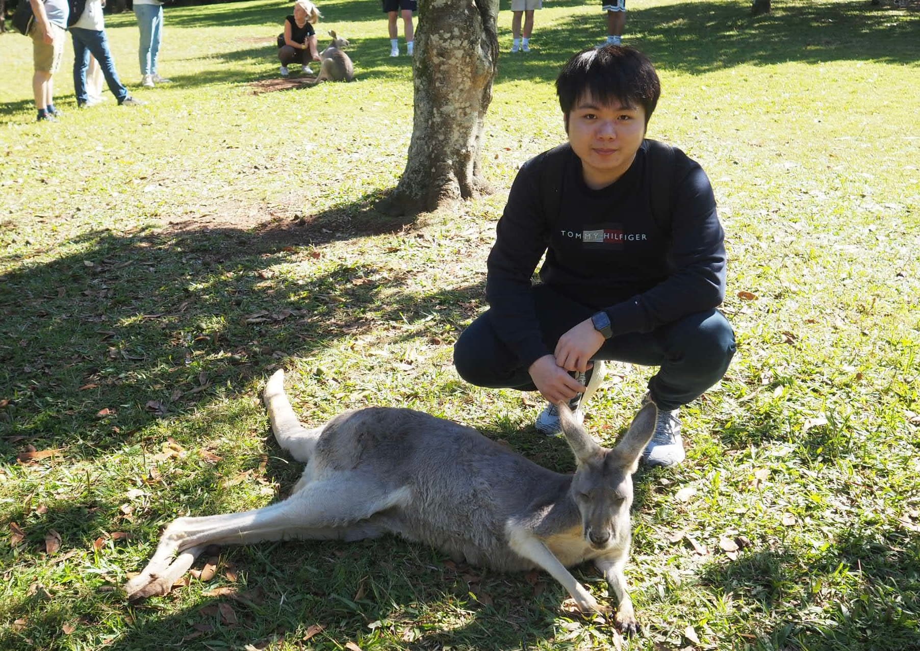 Ricky outdoors with a kangaroo